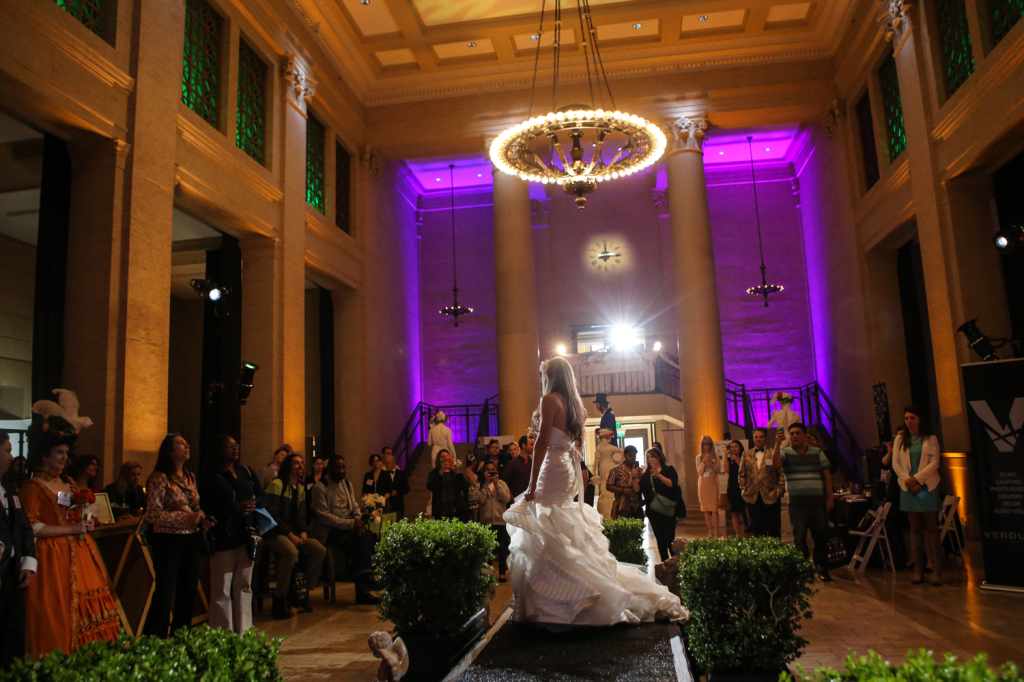 Bride model underneath chandelier lights for vanity wedding show 
