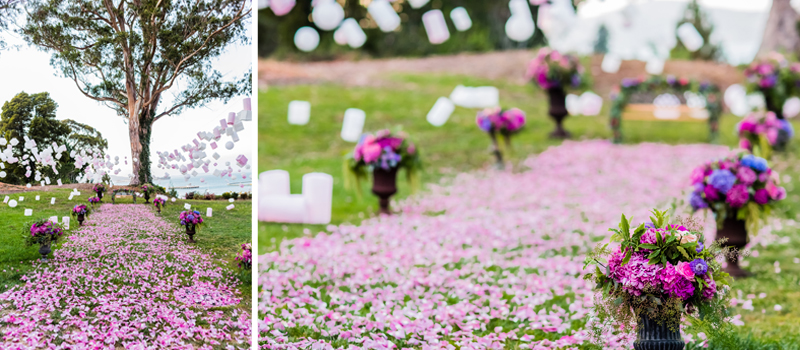 Fairytale proposal set-up and decor with purple flowers and petals set-up on the grass 