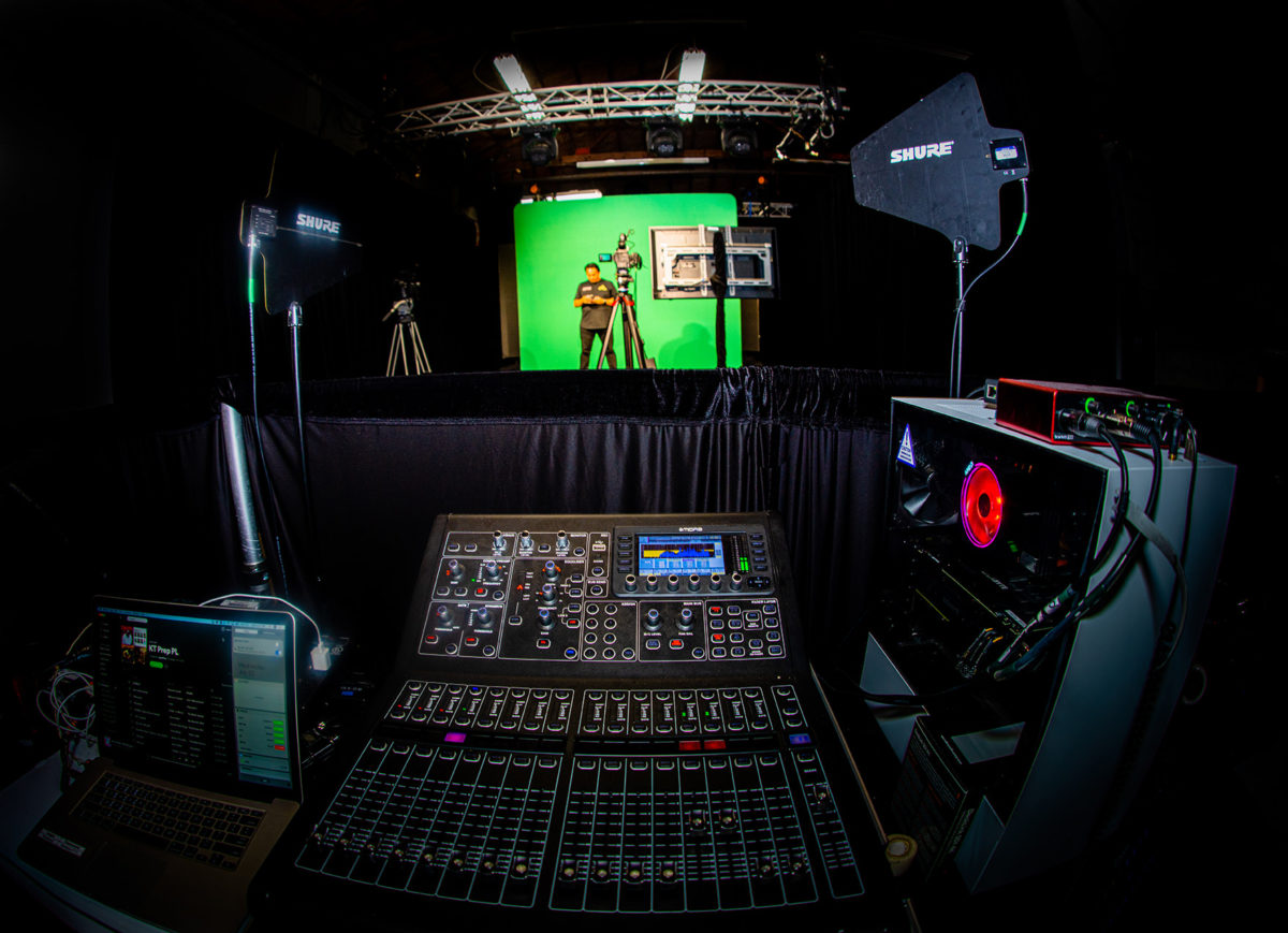 virtual event back stage set-up with camera equipment and green screen backdrop