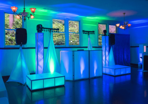 DJ booth lighting and stage set-up with green and blue wall and floor lights