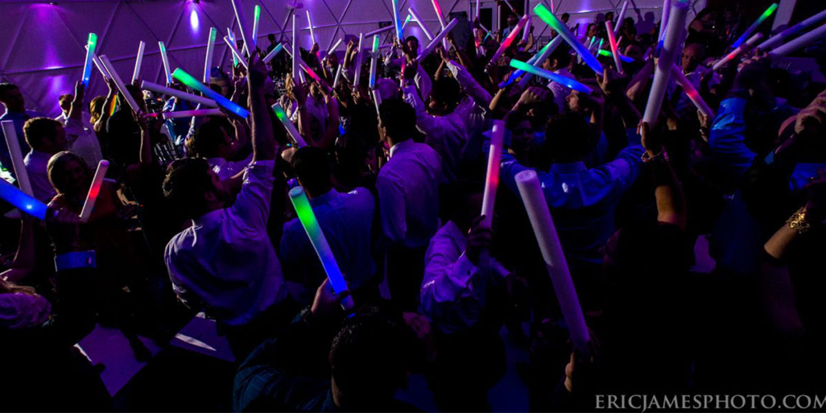 Crowd with multicolored lights on the dance floor