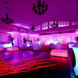 Multicolored venue lighting and red pattern wash dance floor lighting
