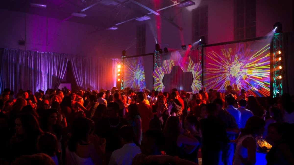 Stage and dance floor lighting with digital screens and projector set-up for corporate event