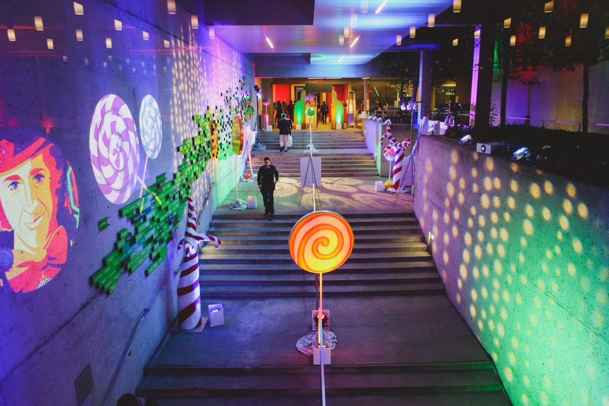 Stair entrance candy deco, lighting and multicolored image projections for corporate event