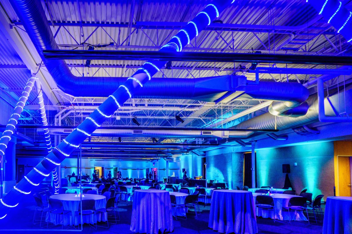 Indoor string lighting and up lighting setup for dining event
