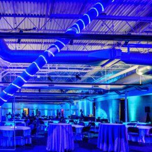 Indoor string lighting and up lighting setup for dining event