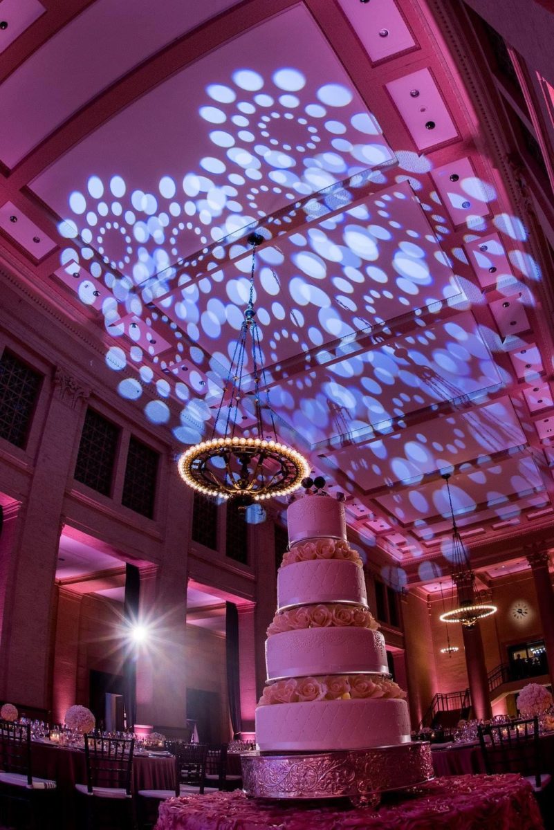 ceiling wash patterned lighting and cake table set-up for wedding