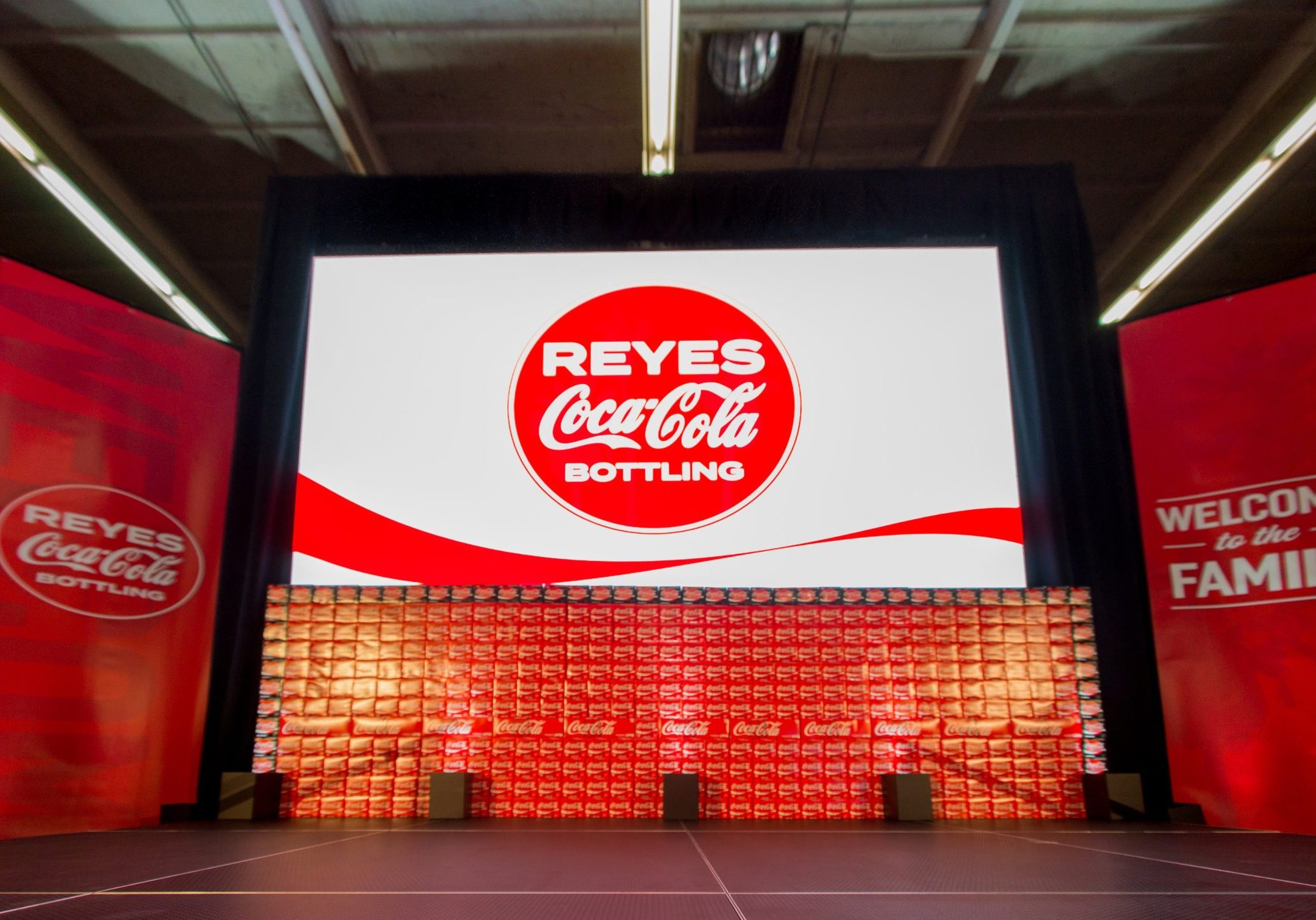 image of coca-cola on a big screen and stage